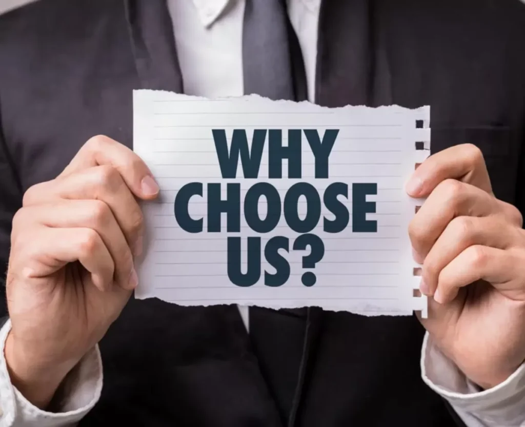 A man holding a teared up page towards the screen with "Why Choose Us?" written on it.